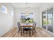 Bright dining room featuring modern chandelier lighting, a stylish table, and expansive windows at 141 Summerwind Dr, Summerville, SC 29483