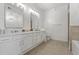 Bright bathroom featuring a double vanity with marble countertops and modern fixtures, with tiled floors and neutral walls at 145 Pier View St # 407, Charleston, SC 29492