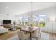 Bright and airy dining area with modern chandelier, large windows, and a spacious layout at 145 Pier View St # 407, Charleston, SC 29492