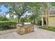 Outdoor grill area with built in stone grill and lush landscaping at 145 Pier View St # 407, Charleston, SC 29492