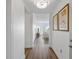 Bright, spacious hallway with hardwood floors and view into the living room with lots of natural light at 145 Pier View St # 407, Charleston, SC 29492