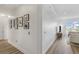 Hallway leading to a bright living room, featuring wood floors, neutral paint, and photo gallery at 145 Pier View St # 407, Charleston, SC 29492