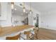 Well-lit kitchen featuring a wooden bar top, white cabinets and chairs, and stainless steel appliances at 145 Pier View St # 407, Charleston, SC 29492