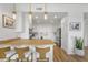 Clean kitchen featuring a wooden bar top, white cabinets and chairs, and stainless steel appliances at 145 Pier View St # 407, Charleston, SC 29492