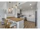 Modern kitchen with white cabinets, wood countertops, stainless steel appliances, and recessed lighting at 145 Pier View St # 407, Charleston, SC 29492