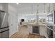 Bright, modern kitchen with stainless steel appliances, wood countertops, and an open concept living area at 145 Pier View St # 407, Charleston, SC 29492