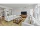 Inviting living room with neutral decor, hardwood floors, and ample natural light from the large windows at 145 Pier View St # 407, Charleston, SC 29492