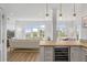 Bright living room with expansive windows, modern lighting, and open layout to the dining area at 145 Pier View St # 407, Charleston, SC 29492