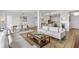 Open-concept living area with modern furnishings, hardwood floors, dining area, and view into the kitchen at 145 Pier View St # 407, Charleston, SC 29492