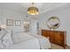 Relaxing main bedroom featuring modern lighting, a wooden dresser, and calming decor at 145 Pier View St # 407, Charleston, SC 29492