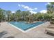 Beautiful community pool surrounded by lounge chairs and lush landscaping at 145 Pier View St # 407, Charleston, SC 29492