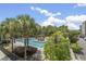 Community pool surrounded by palm trees and lush landscaping at 145 Pier View St # 407, Charleston, SC 29492