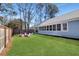 Spacious backyard featuring a fire pit, Adirondack chairs, a grill and wooded backdrop at 1543 Scott Hill Rd, James Island, SC 29412