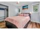 Comfortable bedroom features hardwood floors, soft lighting, closet, and a serene beach painting at 1543 Scott Hill Rd, James Island, SC 29412