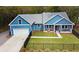 Aerial view of blue home showing the garage, front porch with seating, and black fence surrounding the property at 1543 Scott Hill Rd, James Island, SC 29412
