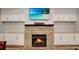 Cozy fireplace with stone surround, built-in cabinets, and a television above at 1543 Scott Hill Rd, James Island, SC 29412