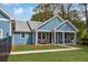 Charming home featuring a welcoming front porch with seating and a beautiful, well-manicured lawn at 1543 Scott Hill Rd, James Island, SC 29412