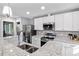 Modern kitchen featuring white cabinets, stainless steel appliances, granite countertops, and a stylish faucet at 1543 Scott Hill Rd, James Island, SC 29412