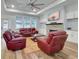 Cozy living room featuring hardwood floors, a fireplace, comfortable seating, and built-in cabinets at 1543 Scott Hill Rd, James Island, SC 29412