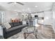 Inviting open-concept living room with a comfortable sofa, glass coffee table, and seamless flow into the kitchen at 1543 Scott Hill Rd, James Island, SC 29412