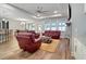 Spacious living room with hardwood floors, comfortable seating, and a modern ceiling fan and lighting at 1543 Scott Hill Rd, James Island, SC 29412
