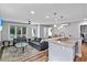 Open-concept living room with a ceiling fan, modern furnishings, and an adjacent kitchen with a breakfast bar at 1543 Scott Hill Rd, James Island, SC 29412