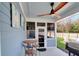 Outdoor porch with wood ceiling fan, a table with chairs, and a grill at 1543 Scott Hill Rd, James Island, SC 29412