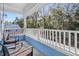 Enjoy the outdoors on this covered porch with seating and views of the surrounding trees at 1543 Scott Hill Rd, James Island, SC 29412