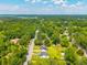 Aerial view showing the property in a tranquil neighborhood with mature trees and a water tower at 171 N Main St, Ridgeville, SC 29472