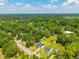 Beautiful aerial view of the property surrounded by mature trees and a well-manicured lawn at 171 N Main St, Ridgeville, SC 29472