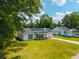An elevated view of a charming home with solar panels and a lush green lawn at 171 N Main St, Ridgeville, SC 29472