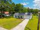 An aerial view of a charming home with solar panels, a lush green lawn, and a long driveway at 171 N Main St, Ridgeville, SC 29472