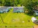 Aerial view of a fenced backyard with a shed, lush green lawn and potential for gardening or outdoor activities at 171 N Main St, Ridgeville, SC 29472