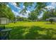Spacious backyard with a lush lawn and mature trees offering shade and privacy at 171 N Main St, Ridgeville, SC 29472