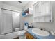 Bright bathroom with a shower-tub combination, white vanity, and built-in storage at 171 N Main St, Ridgeville, SC 29472