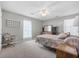 Cozy bedroom featuring carpet, a ceiling fan, and natural light from a window at 171 N Main St, Ridgeville, SC 29472
