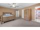 Bedroom with carpet, ceiling fan, natural wood furnishings, and access to the bathroom at 171 N Main St, Ridgeville, SC 29472