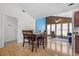Open concept dining area with a dining table and an opening into a sunroom at 171 N Main St, Ridgeville, SC 29472