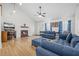 Bright living room features a vaulted ceiling, fireplace, and comfortable blue sectional sofa at 171 N Main St, Ridgeville, SC 29472