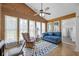 Cozy sunroom bathed in natural light, featuring wood paneling, and comfortable seating at 171 N Main St, Ridgeville, SC 29472