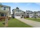 Two-story home with a well-manicured lawn, and a driveway leading to a single-car garage at 1800 Poplar Grove Pl, Summerville, SC 29483