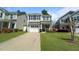 Charming two-story home featuring a well-maintained lawn and a driveway leading to a one-car garage at 1800 Poplar Grove Pl, Summerville, SC 29483