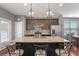 A kitchen with an island with seating, stainless steel appliances, and dark cabinets at 1800 Poplar Grove Pl, Summerville, SC 29483