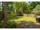 Large backyard with a green lawn, tall privacy fence and mature trees, perfect for outdoor activities at 1813 Parkland Preserve Ln, Charleston, SC 29412