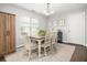 Bright dining room featuring a dining table set for six, natural light, and modern decor at 1813 Parkland Preserve Ln, Charleston, SC 29412