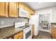 Well-equipped kitchen with white appliances, ample counter space, and convenient layout near dining area at 1813 Parkland Preserve Ln, Charleston, SC 29412