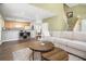 Open-concept living room with views of the kitchen, hardwood floors, and cozy furniture at 1813 Parkland Preserve Ln, Charleston, SC 29412