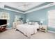 Airy main bedroom boasts a tray ceiling, ceiling fan and bright natural light at 1813 Parkland Preserve Ln, Charleston, SC 29412