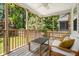 Relaxing screened porch with string lights, wooden deck, white furnishings, and backyard view at 1813 Parkland Preserve Ln, Charleston, SC 29412
