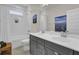 Bathroom featuring a double sink vanity, shower over tub with white subway tile, bright lighting, and neutral wall color at 1821 Mead Ln, Johns Island, SC 29455